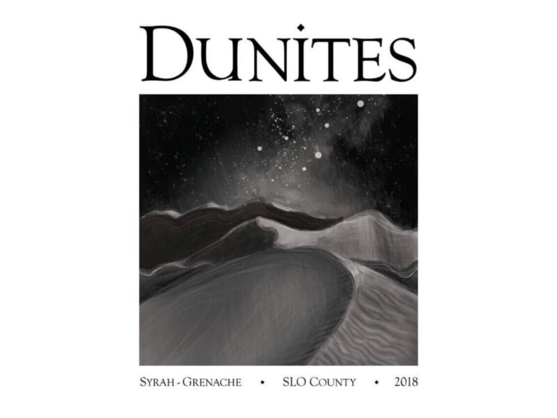 Dunites SLO Coast Syrah-Grenache 2017; Rectangular white label with black text above and below an internal rectangle showing a night scene of sand dunes and sea