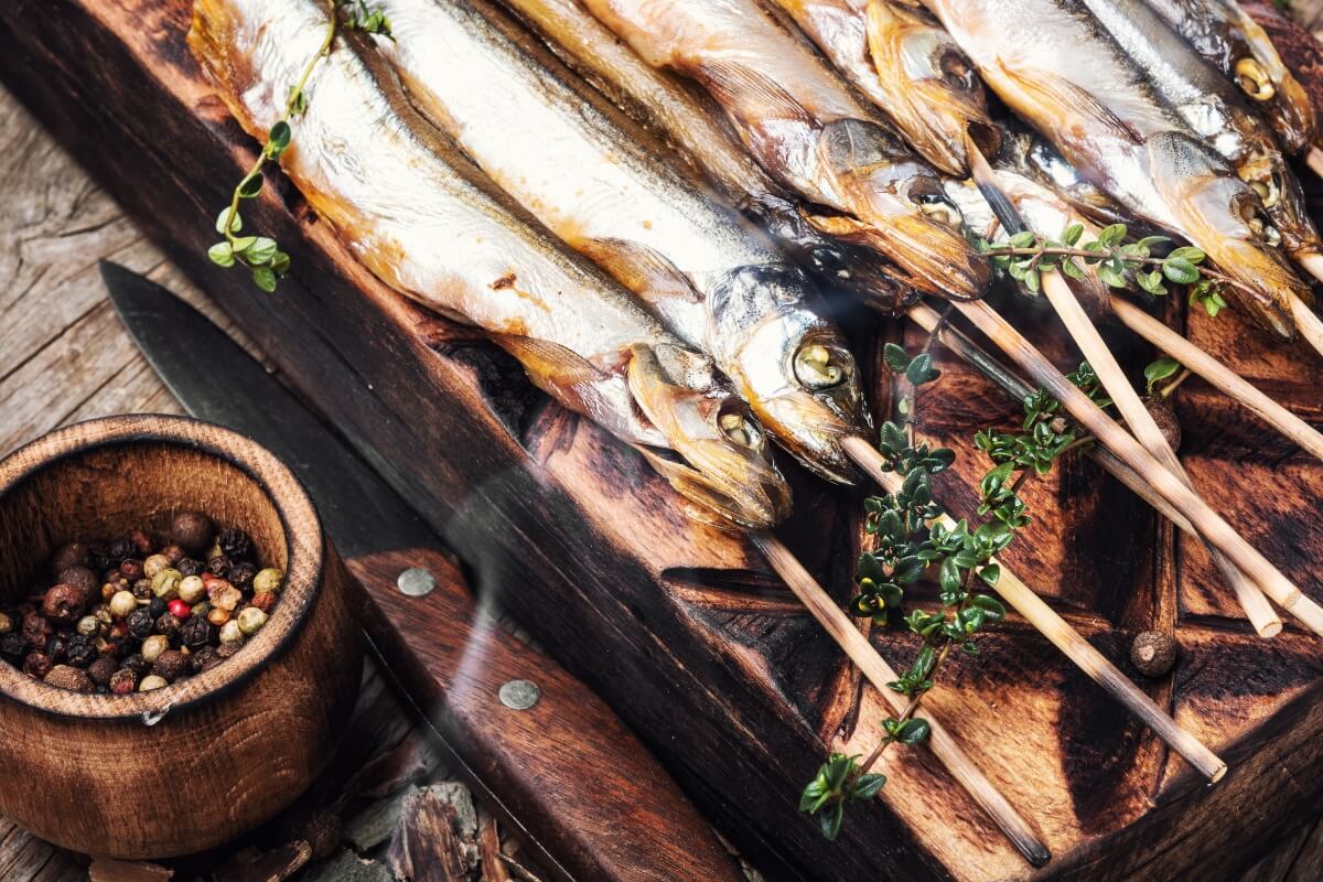 Barbecued smoked fish on skewers